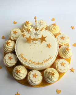cake and cup cakes with gold star topper
