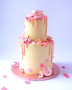 2 tier wedding cake with pink drip and sugar flowers